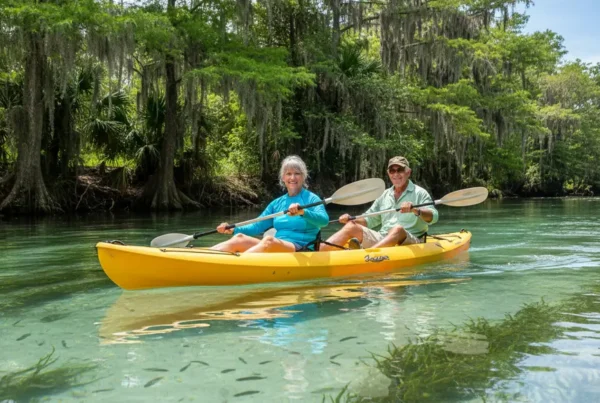 Active senior couple kayaking on the Rainbow River after non-surgical knee pain treatment.